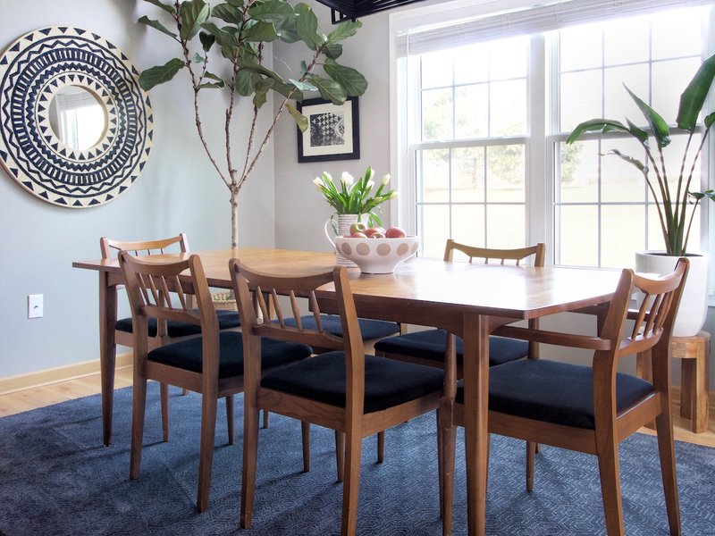 Blue area rug under modern dining room table